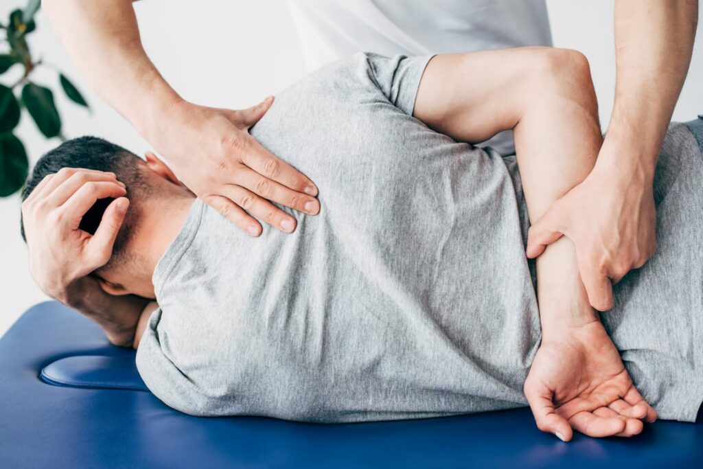 back view of chiropractor massaging back of man ly 2024 11 19 17 35 47 utc