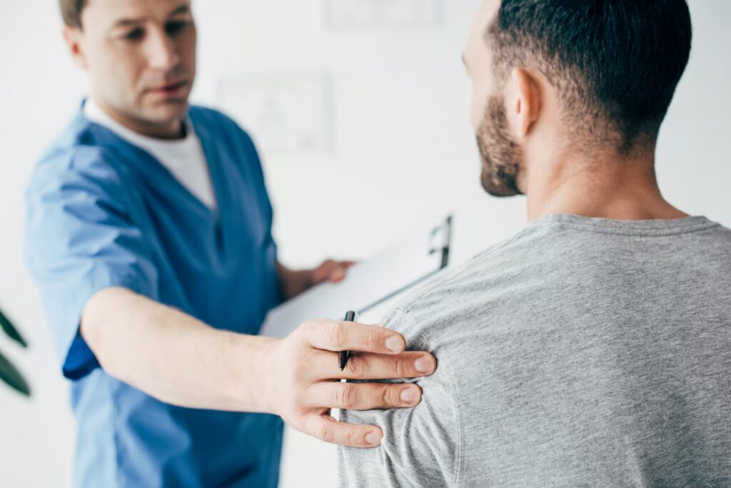 chiropractor with diagnosis examining shoulder of 2024 11 17 13 26 12 utc