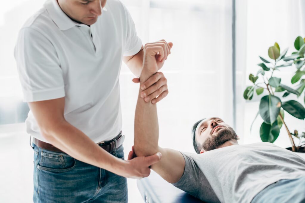 physiotherapist stretching arm of bearded patient 2024 11 13 21 42 16 utc